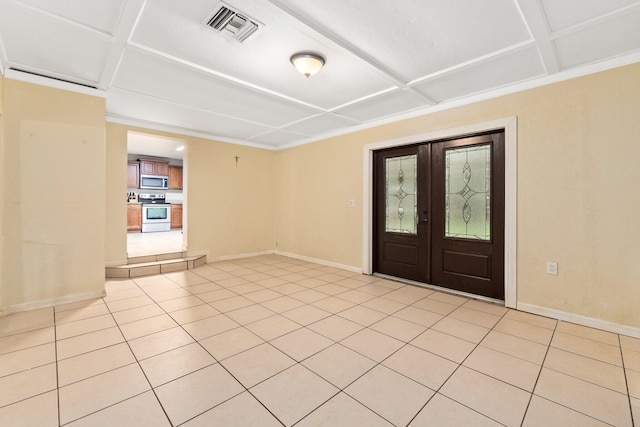 tiled foyer with coffered ceiling and french doors