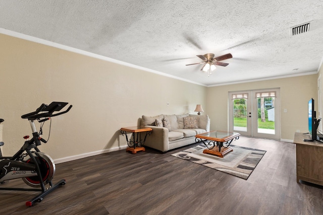 living room featuring french doors, crown molding, dark hardwood / wood-style floors, ceiling fan, and a textured ceiling