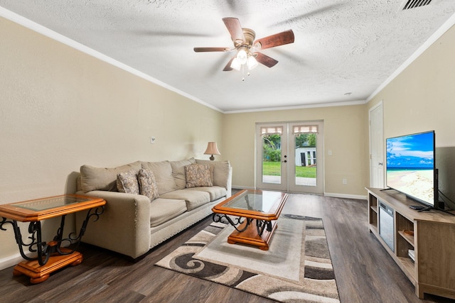 living room featuring ceiling fan, french doors, dark hardwood / wood-style flooring, a textured ceiling, and ornamental molding