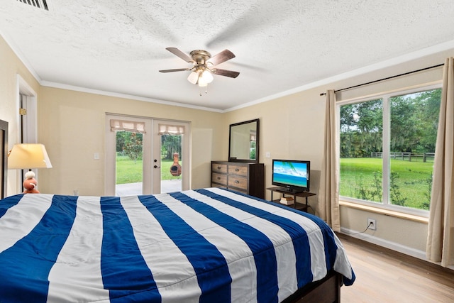 bedroom featuring multiple windows, ceiling fan, and light hardwood / wood-style flooring