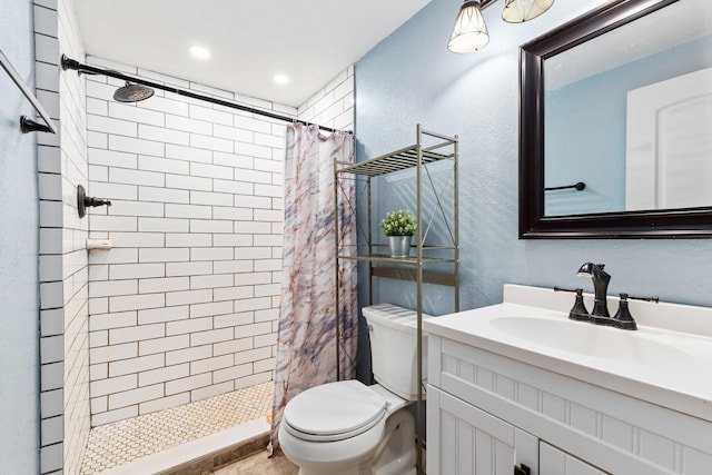 bathroom featuring vanity, toilet, and walk in shower