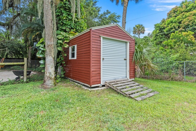 view of outbuilding with a lawn