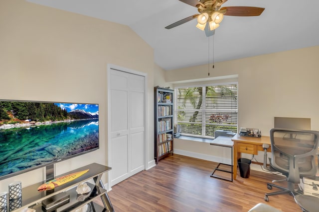 office area with ceiling fan, wood-type flooring, and vaulted ceiling