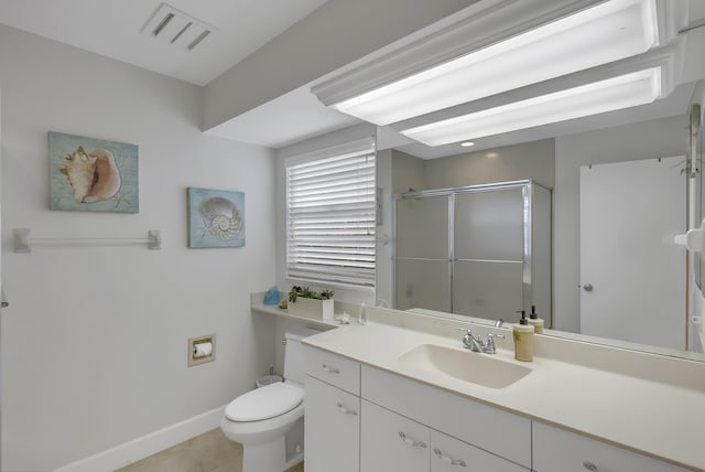 bathroom with tile patterned flooring, vanity, toilet, and a shower with door