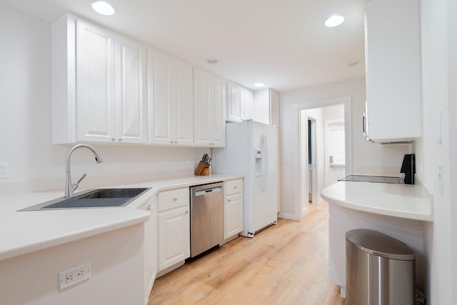 kitchen featuring range, white cabinets, dishwasher, white refrigerator with ice dispenser, and light hardwood / wood-style flooring