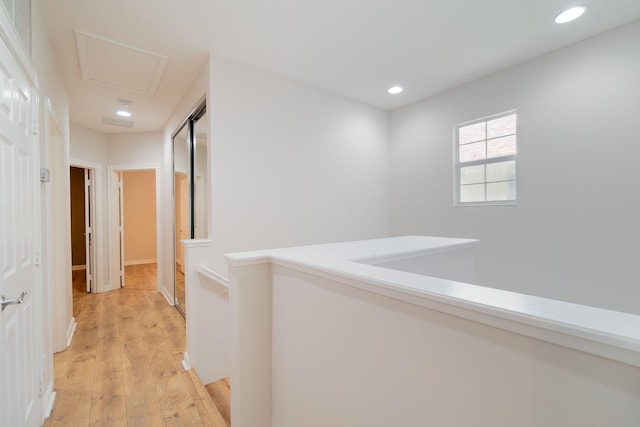 corridor with light hardwood / wood-style flooring