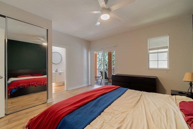 bedroom featuring sink, a closet, wood-type flooring, and ceiling fan