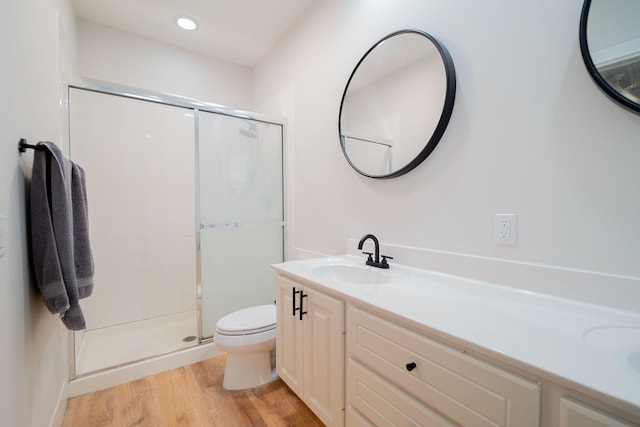 bathroom with vanity, toilet, an enclosed shower, and hardwood / wood-style floors