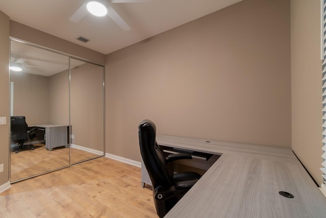 home office featuring ceiling fan and light hardwood / wood-style floors