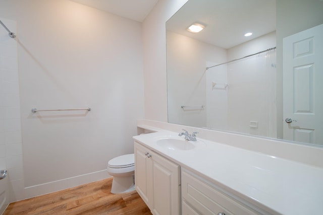 bathroom with vanity, hardwood / wood-style flooring, and toilet