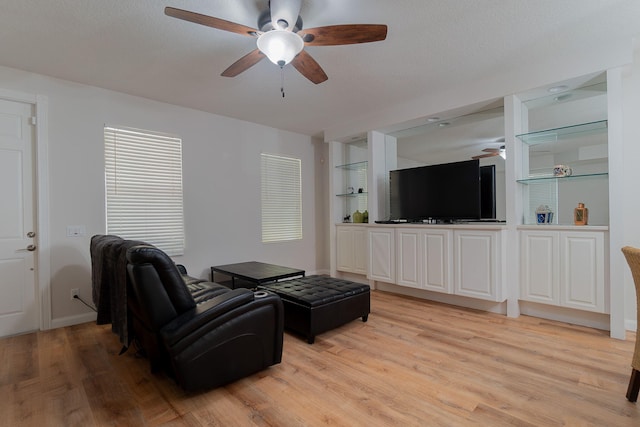 living room featuring ceiling fan and light wood-type flooring