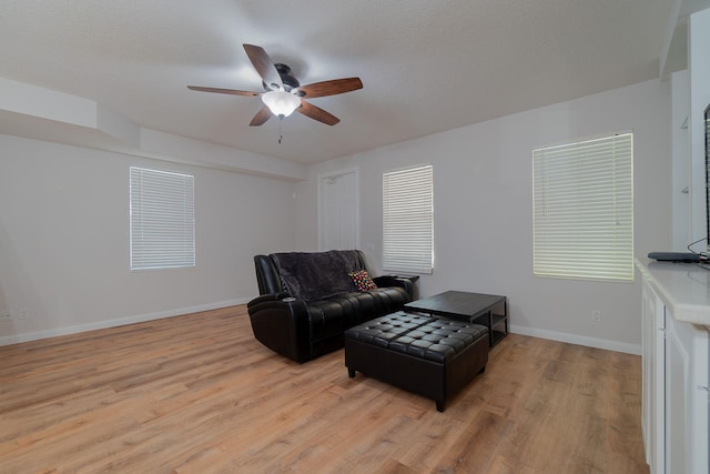 living room featuring light hardwood / wood-style floors and ceiling fan