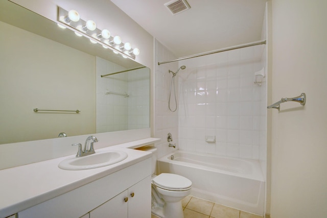 full bathroom with tile patterned floors, tiled shower / bath, vanity, and toilet