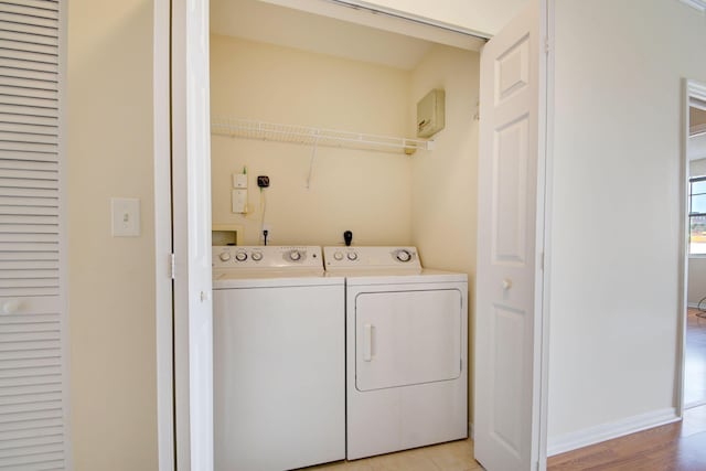 laundry area featuring light hardwood / wood-style flooring and independent washer and dryer