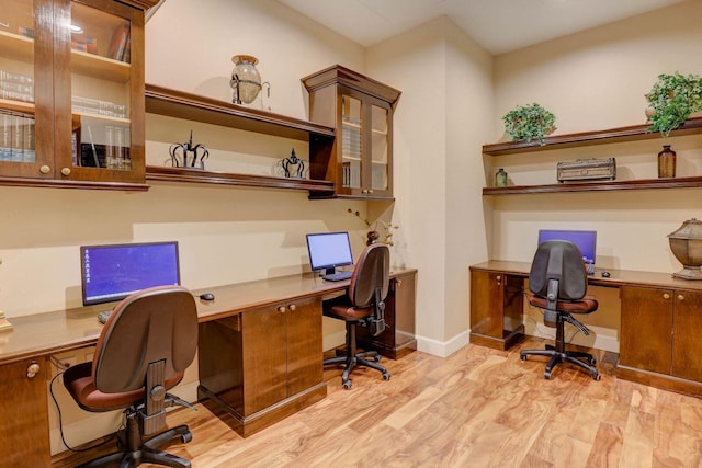 home office featuring built in desk and light wood-type flooring