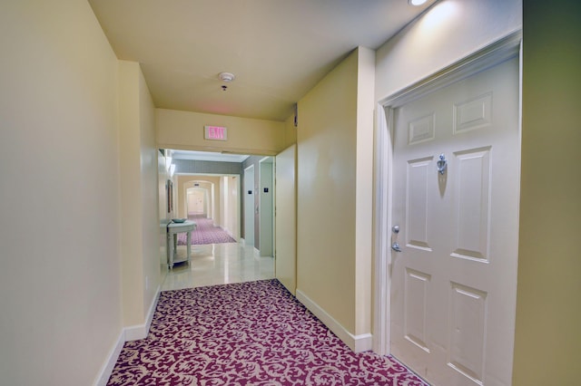 corridor with light tile patterned flooring