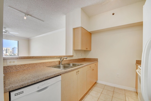 kitchen with white appliances, track lighting, sink, light tile patterned floors, and a textured ceiling