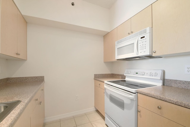 kitchen with light brown cabinets, white appliances, sink, and light tile patterned floors