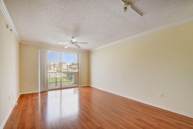 unfurnished room featuring crown molding, light hardwood / wood-style flooring, ceiling fan, and a textured ceiling