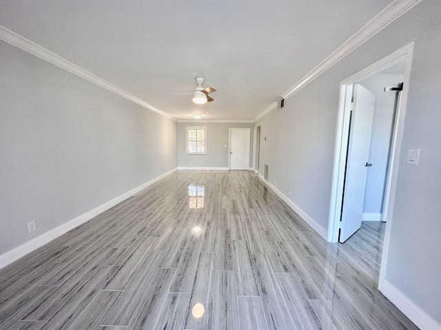 spare room with ornamental molding, ceiling fan, and light wood-type flooring