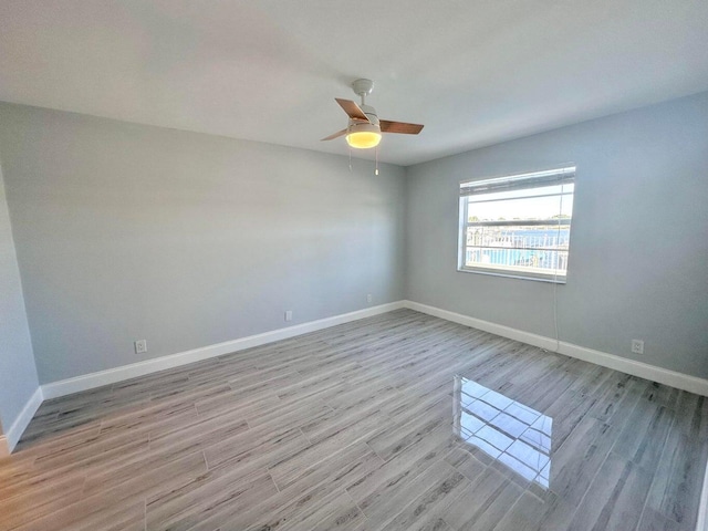 spare room featuring ceiling fan and light wood-type flooring