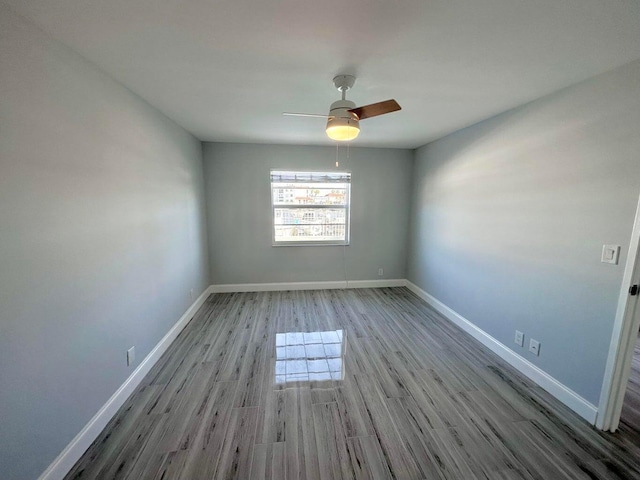 spare room with light hardwood / wood-style floors and ceiling fan