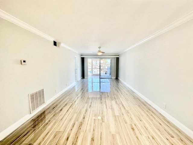 empty room featuring ornamental molding and light hardwood / wood-style flooring