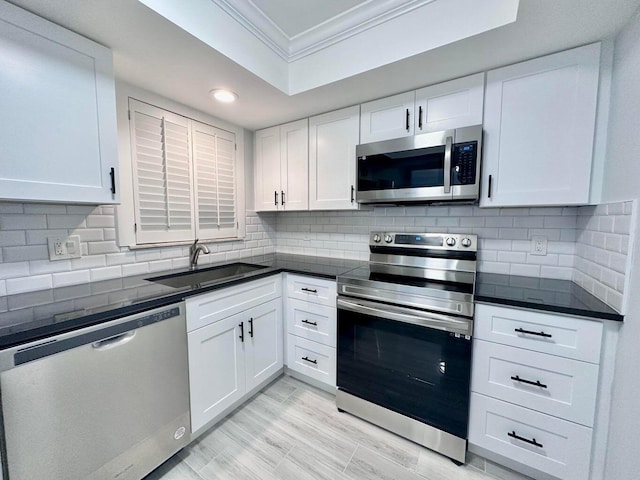 kitchen featuring white cabinetry, stainless steel appliances, and sink