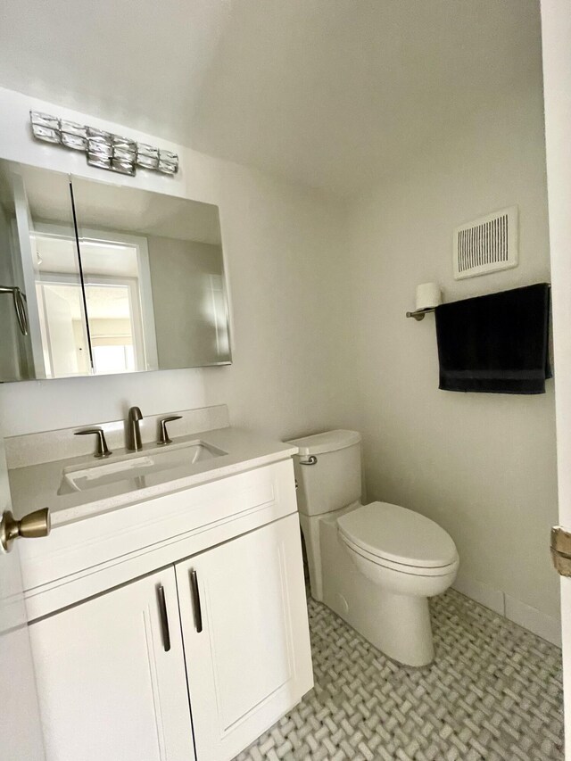 bathroom featuring vanity and toilet