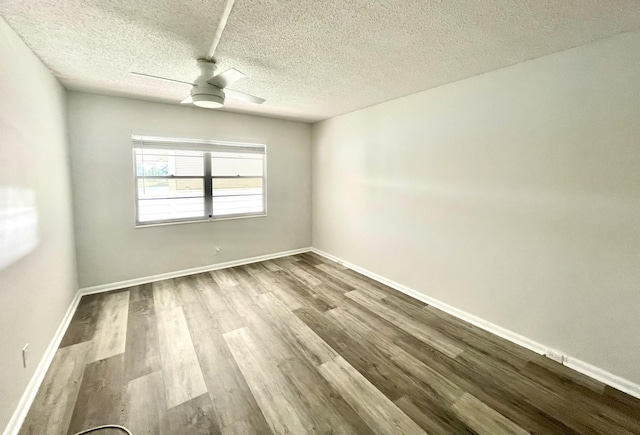 empty room featuring ceiling fan, light hardwood / wood-style flooring, and a textured ceiling