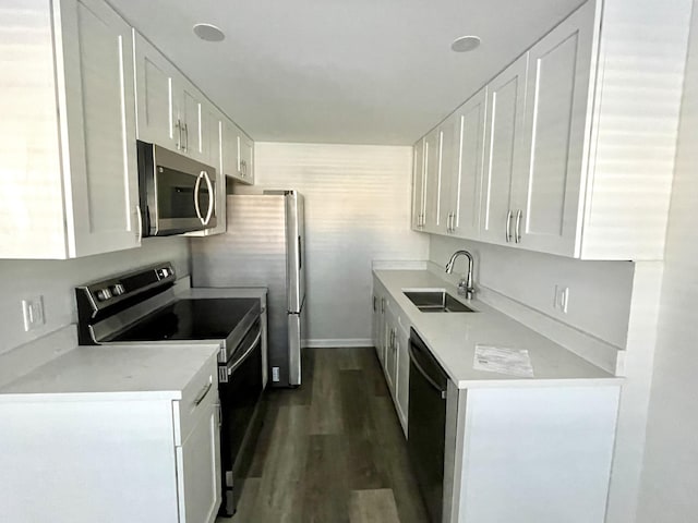 kitchen with white cabinetry, sink, dark hardwood / wood-style floors, and appliances with stainless steel finishes