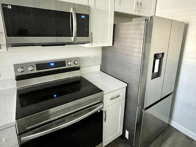 kitchen featuring white cabinetry and appliances with stainless steel finishes