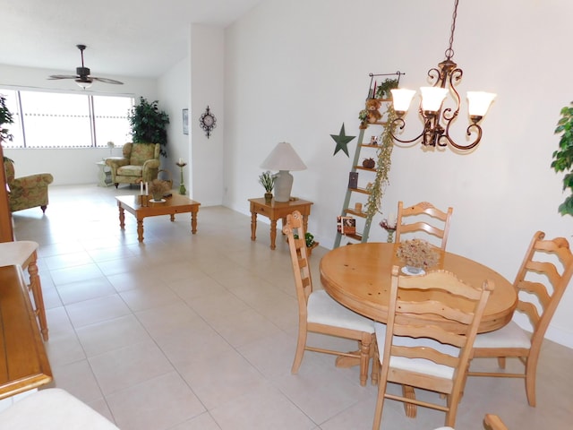 tiled dining room featuring ceiling fan with notable chandelier