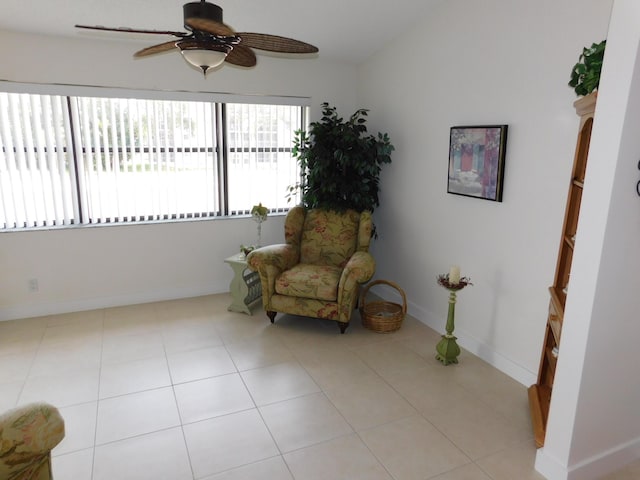 sitting room with ceiling fan and light tile patterned floors