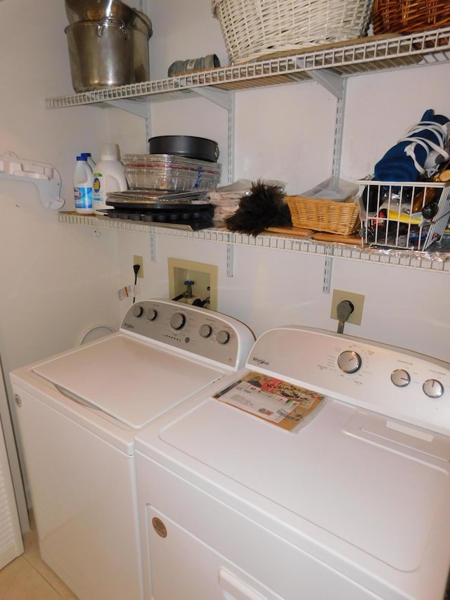 laundry room with separate washer and dryer and tile patterned floors