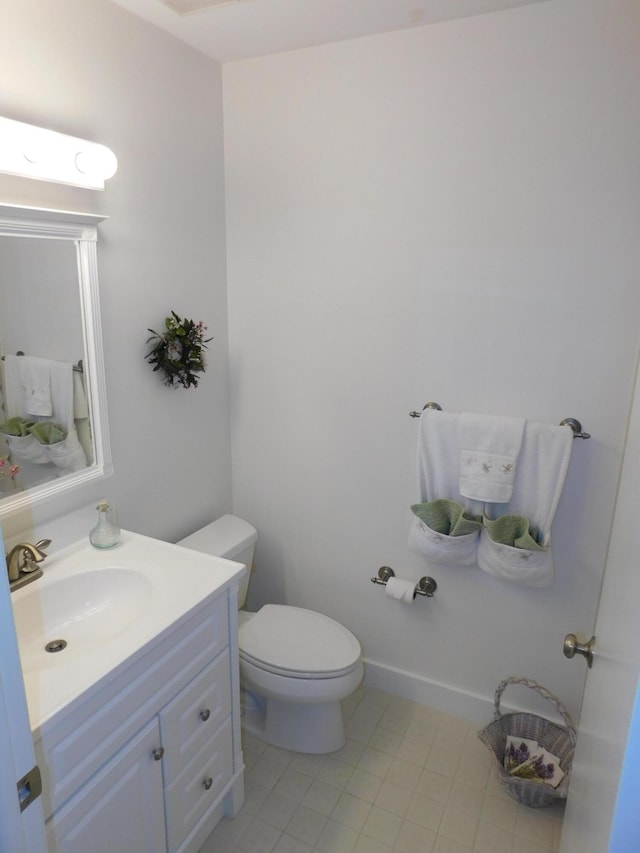 bathroom featuring toilet and vanity