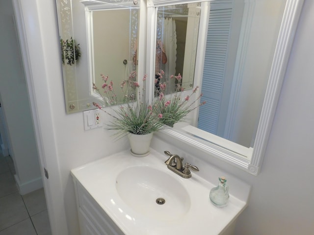 bathroom with tile patterned flooring and vanity