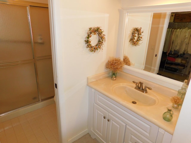 bathroom with vanity, tile patterned flooring, and walk in shower