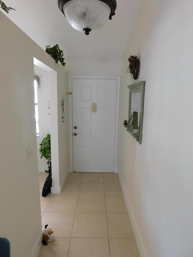 hall featuring light tile patterned floors