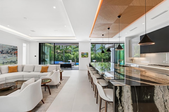 interior space featuring light tile patterned floors and a tray ceiling