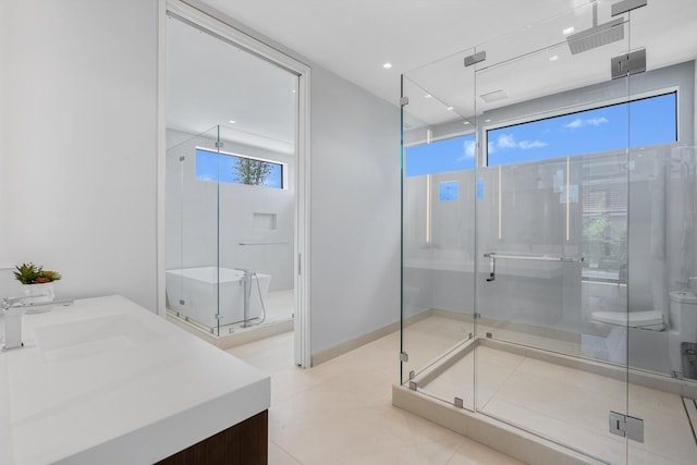 bathroom with tile patterned flooring, vanity, toilet, and a shower with shower door