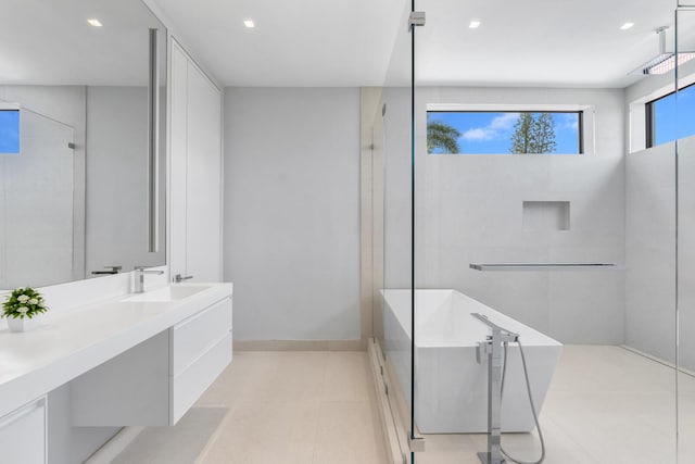 bathroom with tile patterned floors, vanity, and separate shower and tub