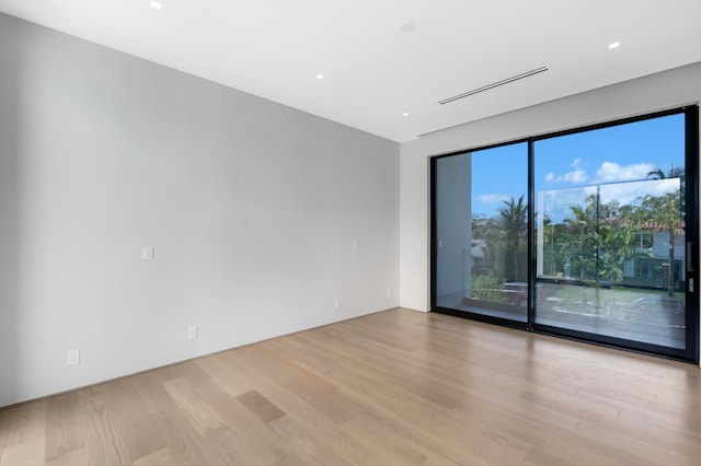 unfurnished room featuring light hardwood / wood-style floors