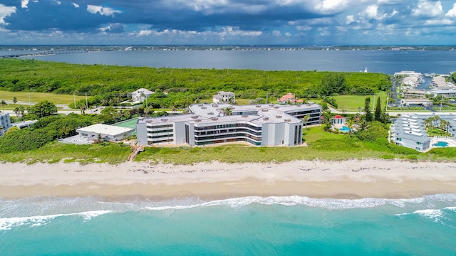 drone / aerial view featuring a water view and a beach view