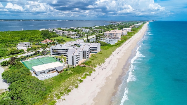 drone / aerial view with a water view and a beach view