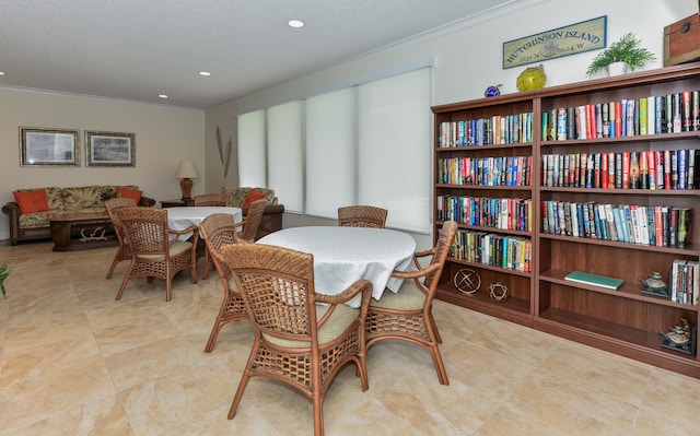 dining area featuring a textured ceiling and ornamental molding