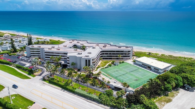 drone / aerial view featuring a water view and a view of the beach