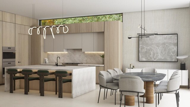 kitchen featuring an island with sink, backsplash, hanging light fixtures, stainless steel double oven, and a breakfast bar area