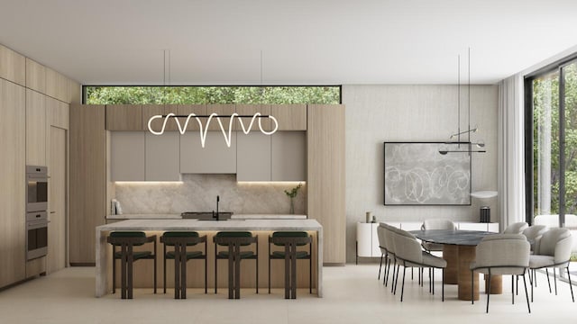 dining room with sink, a healthy amount of sunlight, floor to ceiling windows, and light tile flooring