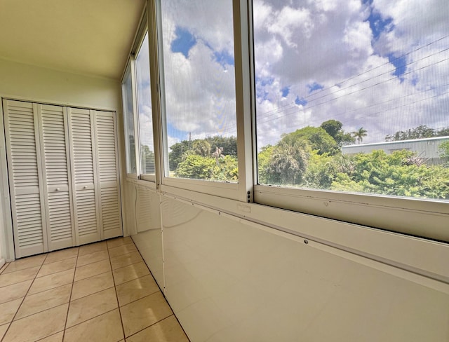 bedroom with light tile patterned flooring and a closet